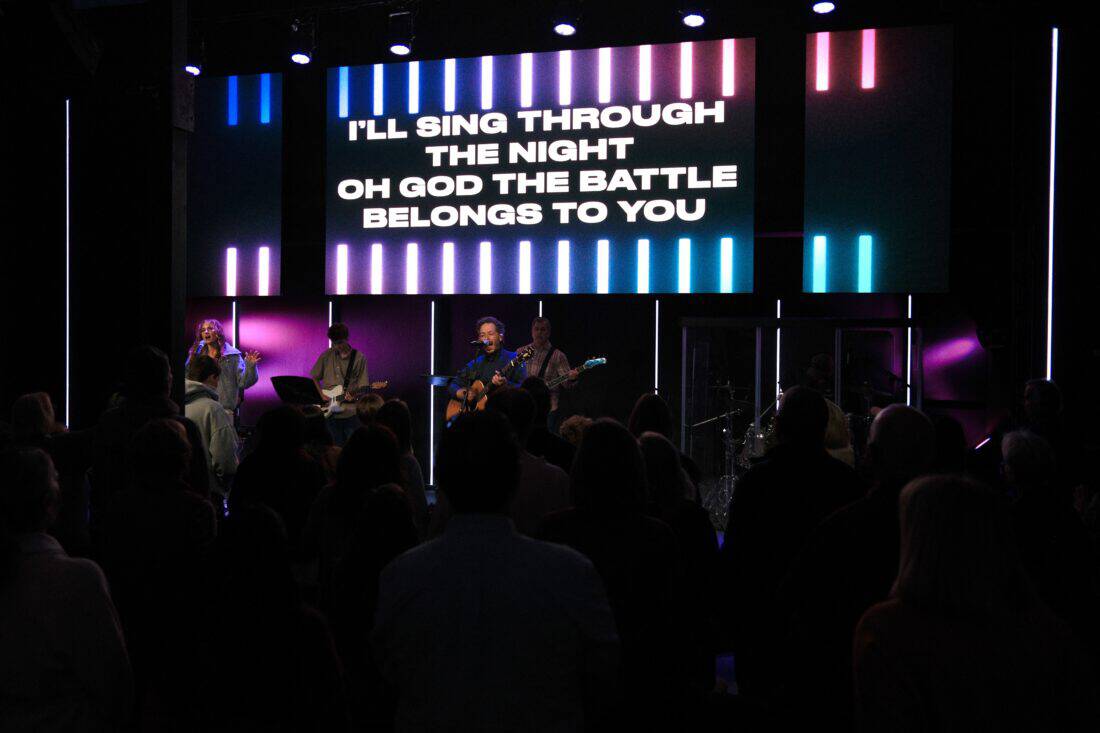 Live worship service at Canyon Springs Church with musicians and congregation.