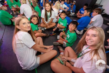 Group of children and teens sitting on the floor at Canyon Springs Church event.