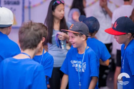 Youth group members wearing blue shirts and caps at Canyon Springs Church event.