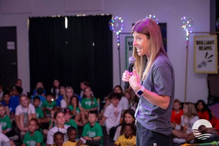 Woman speaking to children at Canyon Springs Church youth event.