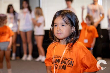 Children participating in youth event at Canyon Springs Church, wearing orange shirts.