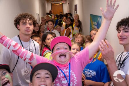 Group of diverse children and teens at Canyon Springs Church youth event, smiling and having fun.