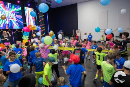 Children enjoying a lively event with balloons and games at Canyon Springs Church.