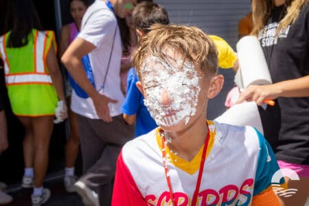 Child with whipped cream on face at Canyon Springs Church youth event.