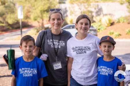Happy group of children and adult at Canyon Springs Church community event outdoors.