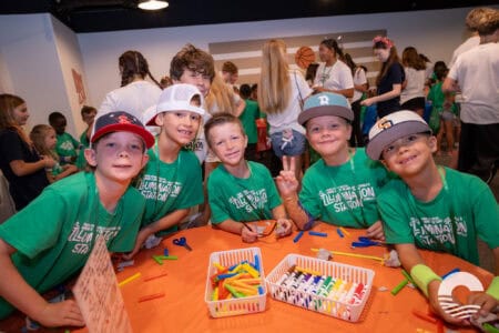 Group of smiling children at Canyon Springs Church youth event, engaging in fun activities.