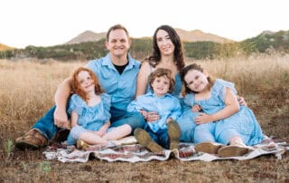 Family sitting on blanket outdoors at Canyon Springs Church.