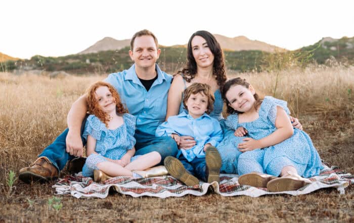 Family sitting on blanket outdoors at Canyon Springs Church.