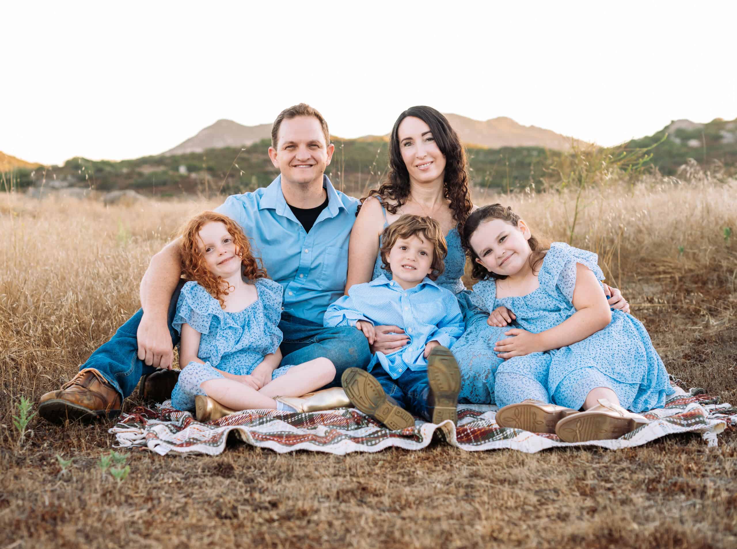 Family sitting on blanket outdoors at Canyon Springs Church.