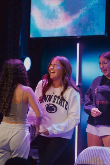 Group of happy teenagers enjoying fellowship at Canyon Springs Church.