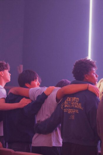 Youth group members standing together with arms around each other at Canyon Springs Church.