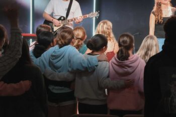Youth group worship session at Canyon Springs Church with music and community.