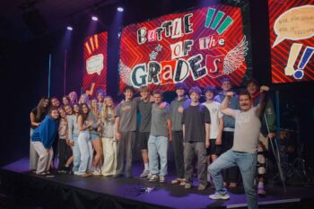 Group of teenagers and leaders on stage during Canyon Springs Church youth event.