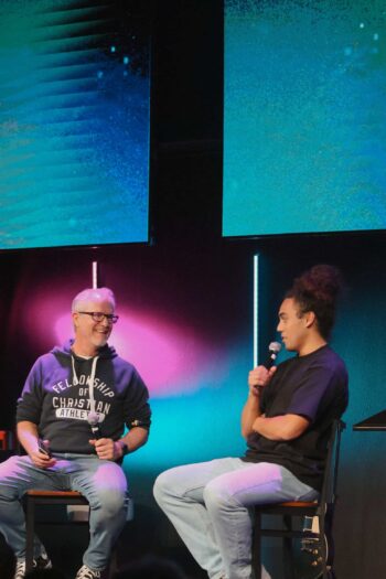 Youth discussion at Canyon Springs Church with two young women on stage.