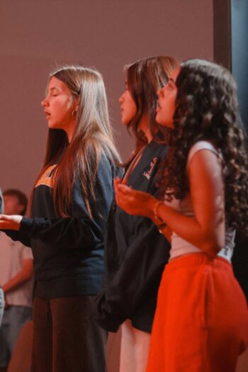 Youth group members praying during church service at Canyon Springs Church.