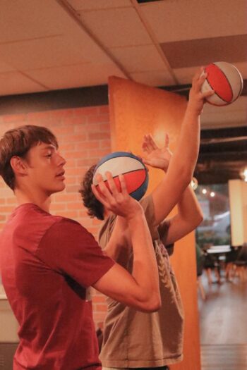 Youth playing basketball indoors at Canyon Springs Church.