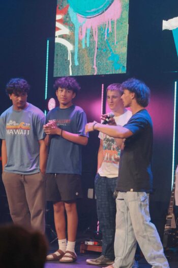 Teenagers participating in youth worship night at Canyon Springs Church stage.