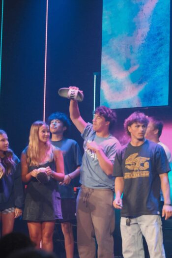 Group of teenagers at Canyon Springs Church youth event on stage.