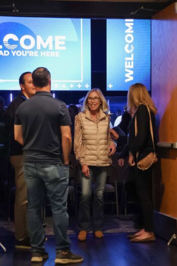 People socializing at Canyon Springs Church welcome event.